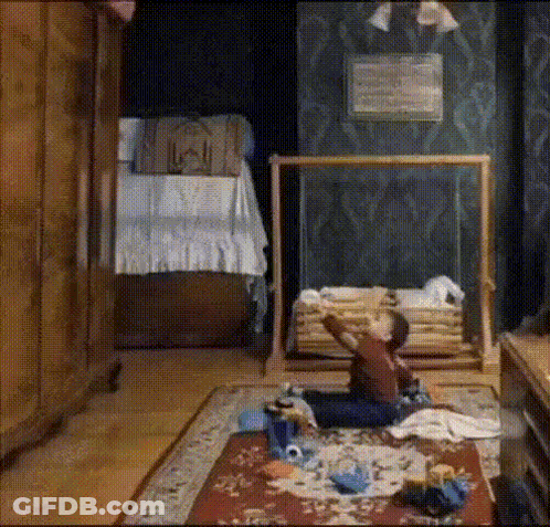 A Child Is Sitting On The Floor In A Room GIF