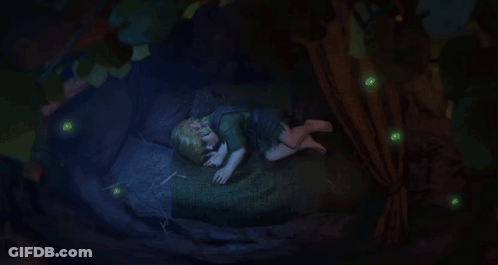 A Child Is Sleeping Under A Tree With Glowing Green Lights Around GIF