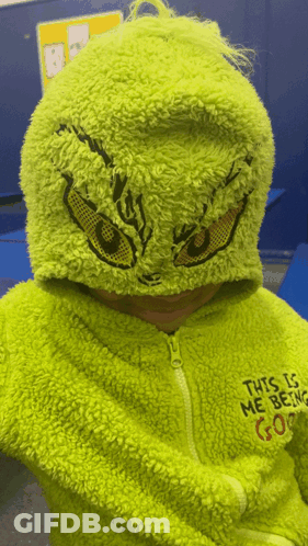 A Child Is Wearing A Grinch Costume With The Words This Is Me Being Gone On The Back GIF