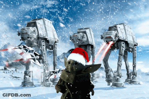 A Child Wearing A Santa Hat Stands In Front Of At At Vehicles GIF