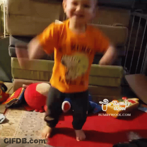 A Child Wearing An Orange Shirt That Says Winnie The Pooh On It GIF