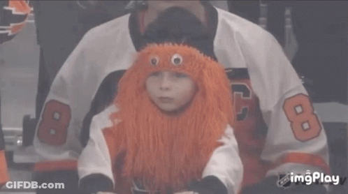 A Child Wearing An Orange Wig And A Jersey With The Number 8 GIF