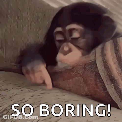 A Chimpanzee Is Laying On A Bed With Its Eyes Closed And Pointing At Something . GIF