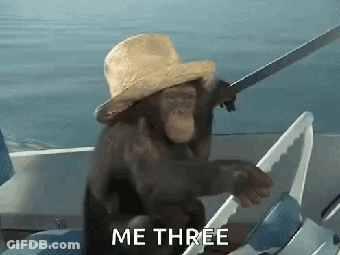 A Chimpanzee Wearing A Hat And Holding A Sword Is Sitting On A Boat . GIF