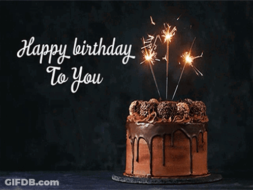 A Chocolate Birthday Cake With Sparklers On Top And The Words Happy Birthday To You Below It GIF