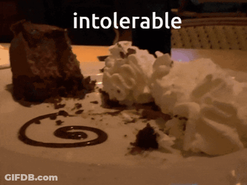 A Chocolate Dessert With Whipped Cream And Chocolate Sauce With The Word Intolerable Written Above It GIF