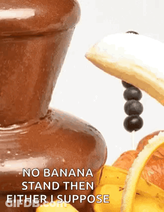A Chocolate Fountain With A Banana And Blueberries On Top Of It . GIF