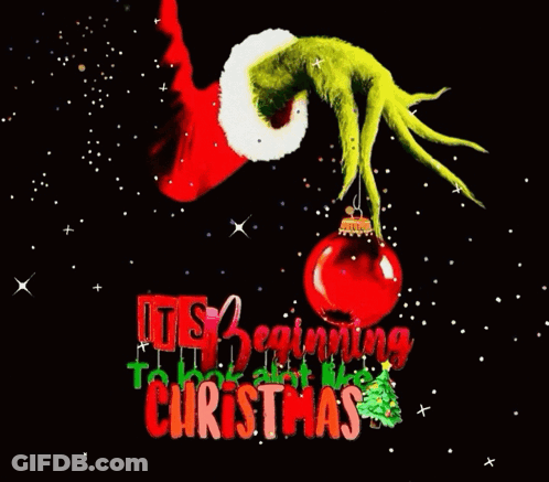 A Christmas Card With A Grinch Holding A Christmas Ornament . GIF