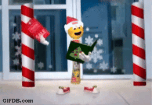 A Christmas Elf Is Holding A Book And A Tube Of Toothpaste . GIF