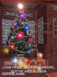 A Christmas Tree In A Living Room With Gifts Underneath It GIF