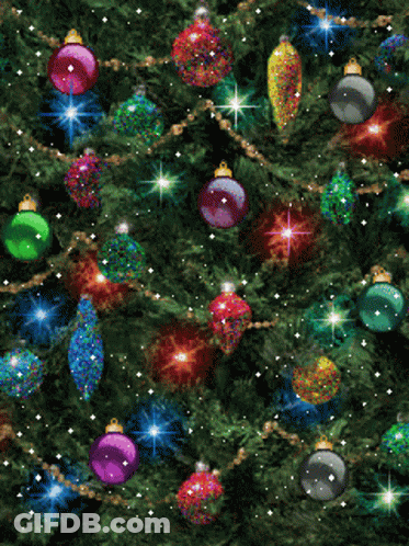 A Christmas Tree Is Decorated With Lots Of Colorful Ornaments GIF