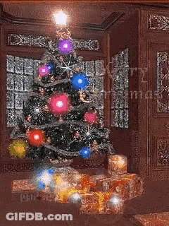 A Christmas Tree With Gifts Underneath It And The Words Merry Christmas On The Bottom GIF