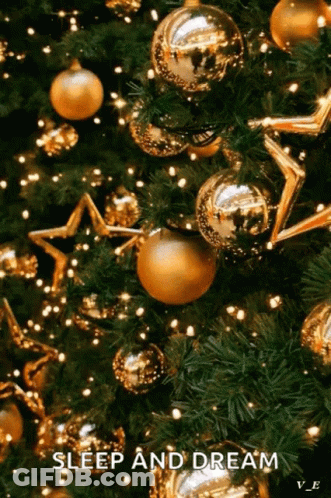 A Christmas Tree With Gold Decorations And Lights And The Words `` Sleep And Dream '' . GIF