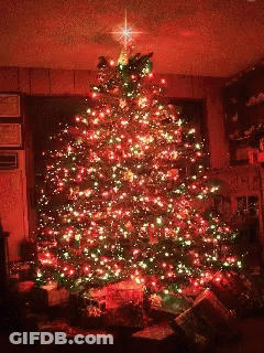 A Christmas Tree With Red And Green Lights And A Star On Top Of It GIF