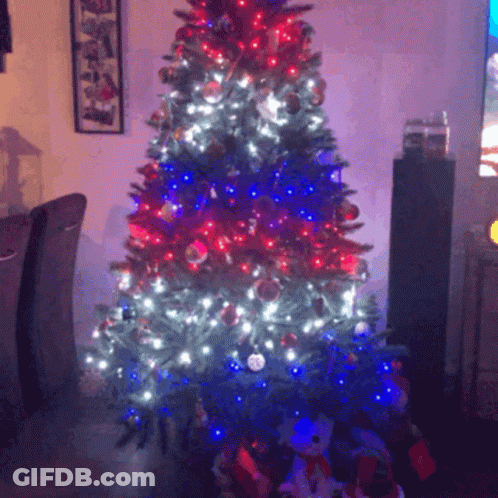 A Christmas Tree With Red White And Blue Lights And Decorations GIF