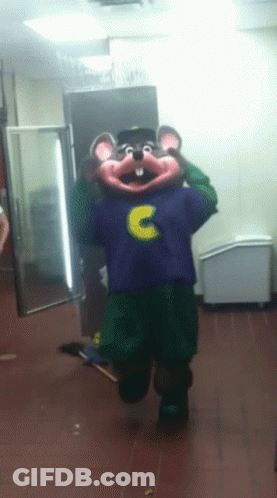 A Chuck E Cheese Mascot In A Purple Shirt With The Letter C On It GIF