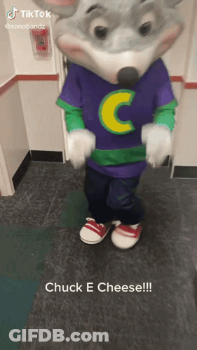 A Chuck E Cheese Mascot Is Standing On A Tiled Floor GIF