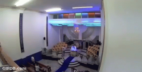 A Church With A Blue Carpet And A Podium In The Middle GIF
