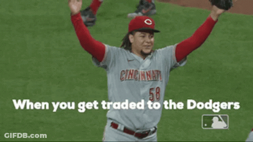 A Cincinnati Baseball Player Is Holding His Arms In The Air GIF