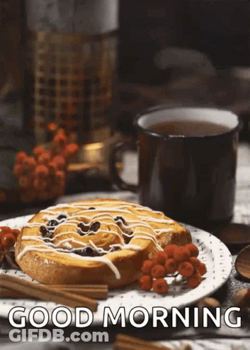 A Cinnamon Roll On A Plate Next To A Cup Of Tea With The Words Good Morning Written Below It GIF