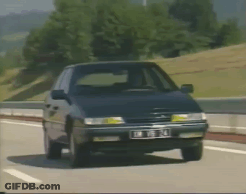 A Citroen Car Is Driving Down A Highway With A License Plate That Says Jm T14 GIF