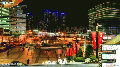 A City At Night With A Sign That Says ' New V ' On It GIF