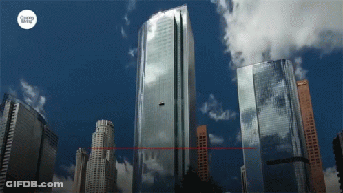 A City Skyline With A Country Living Logo On The Bottom Right GIF