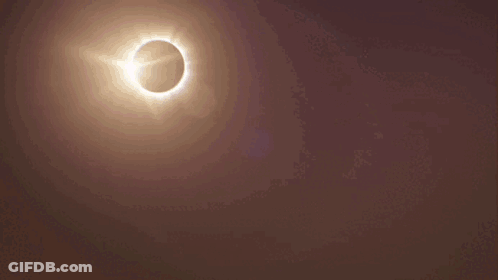 A City Skyline With A Partial Eclipse Of The Sun GIF