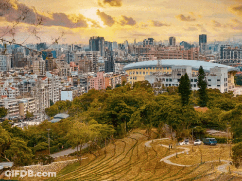 A Cityscape With A Stadium In The Foreground And A Park In The Foreground GIF
