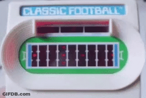 A Classic Football Game Is Being Played On A Table . GIF
