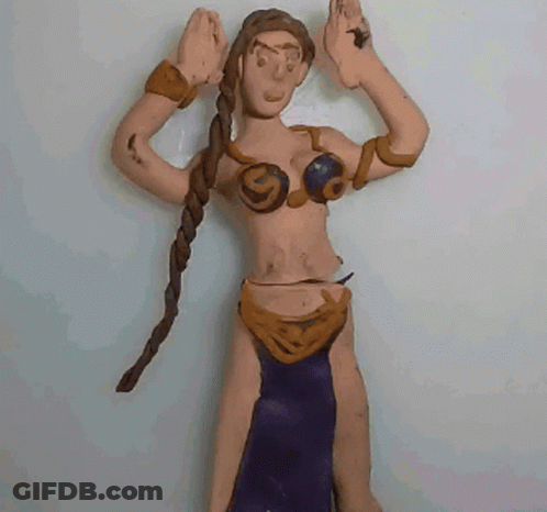 A Clay Figure Of A Woman With Braids And A Purple Skirt GIF