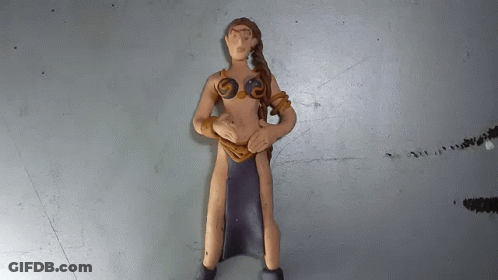 A Clay Figurine Of A Woman With A Black Skirt GIF