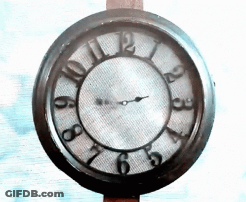A Clock That Has The Hands On The Numbers 1 And 12 GIF