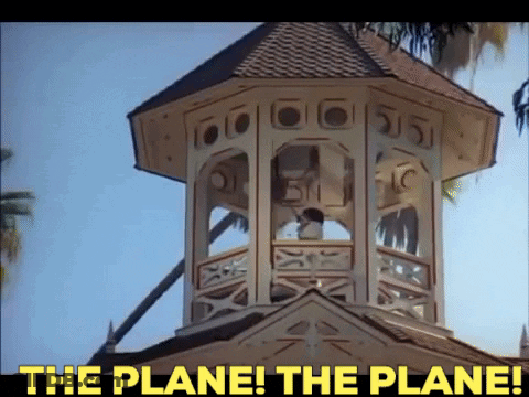 A Clock Tower With The Words " The Plane The Plane " Above It GIF