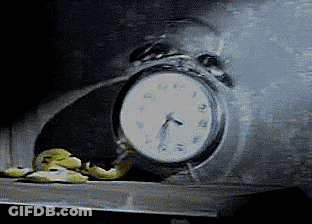 A Clock With A Face On It Shows That It Is Almost 5:00 GIF