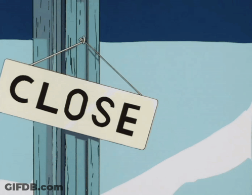 A Close Sign Is Hanging On A Pole In The Snow GIF