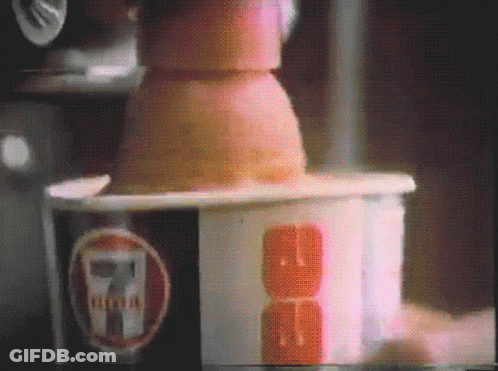A Close Up Of A 7 Eleven Cup With A Cube In It GIF