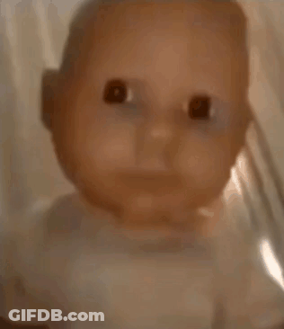 A Close Up Of A Baby Doll In A Glass Jar . GIF