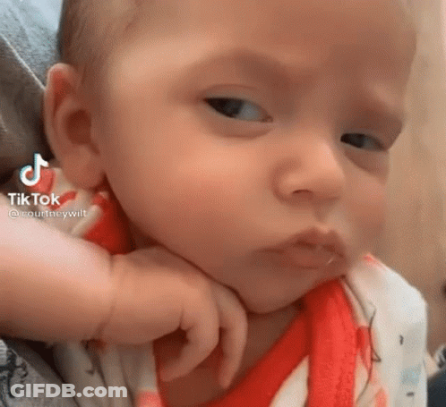 A Close Up Of A Baby Making A Funny Face . GIF