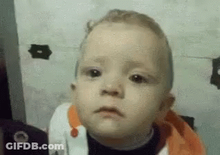 A Close Up Of A Baby Making A Funny Face . GIF