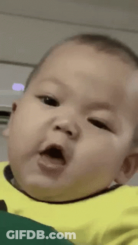 A Close Up Of A Baby Making A Funny Face With His Mouth Open . GIF