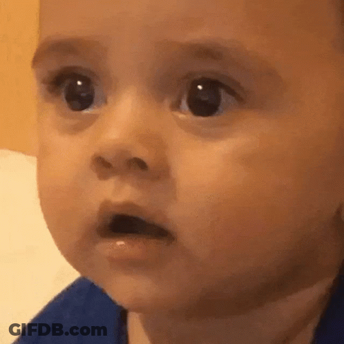 A Close Up Of A Baby Making A Surprised Face GIF