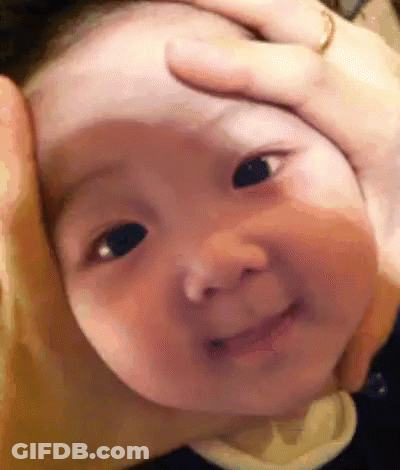 A Close Up Of A Baby 'S Face With A Person Holding It . GIF