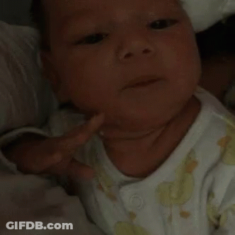 A Close Up Of A Baby 'S Face With A White Shirt On GIF