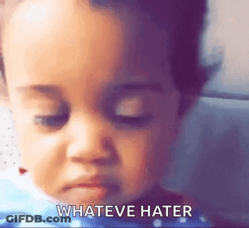 A Close Up Of A Baby 'S Face With The Words " Whateve Hater " Written Below It GIF
