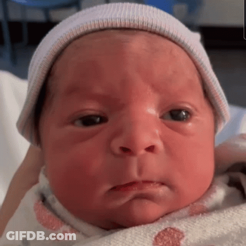 A Close Up Of A Baby Wearing A Hat GIF