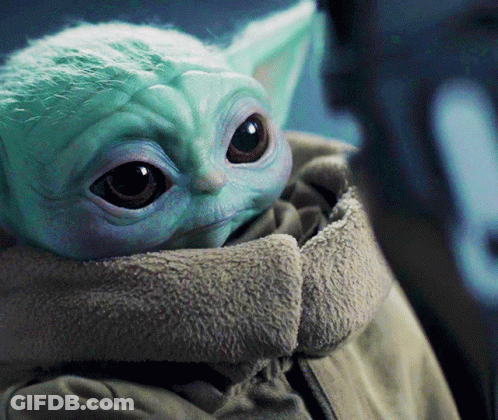 A Close Up Of A Baby Yoda In A Jacket GIF