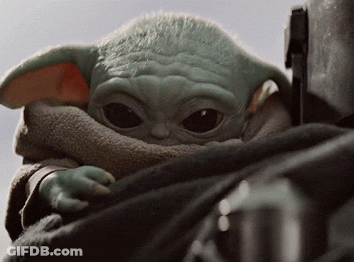 A Close Up Of A Baby Yoda Looking Up GIF