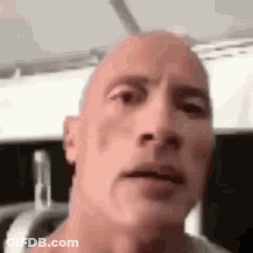 A Close Up Of A Bald Man 'S Face . GIF