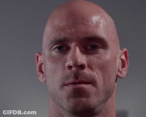 A Close Up Of A Bald Man 'S Face With A Hand Touching His Forehead GIF